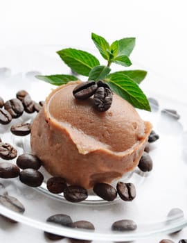 Ice cream decorated with fresh mint and coffee beans