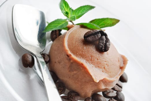 Ice cream decorated with fresh mint and coffee beans