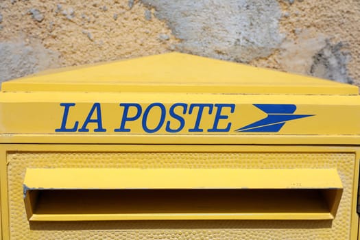 Seillans, France - June 19, 2021: La Poste, A French Yellow Post Box In The Street Of Seillans In The South Of France, Europe. Close Up View