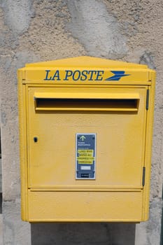 Seillans, France - June 19, 2021: La Poste, A French Yellow Post Box In The Street Of Seillans In The South Of France, Europe. Close Up View