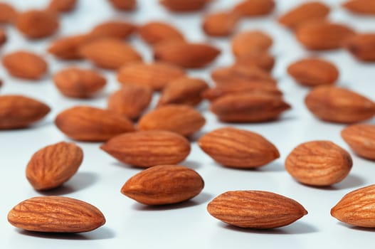 Background of almonds. Fried almonds. Scattered almond grains. Background for advertising, layout, mockup.
