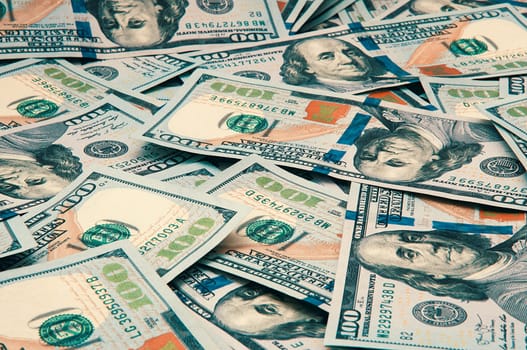 Cash hundred dollar bills, dollar background image. Scattered dollars. A big pile of dollars. Background of North American dollar bills. Color style. Top view for collage and presentation editing.