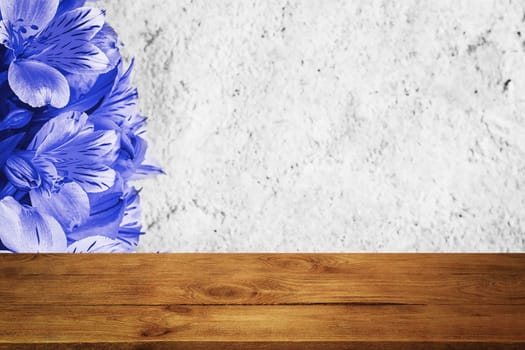 Background flowers on a textured stucco wall and blank wooden planks in the foreground. For product demonstrations, free space, layout, mockup, perspective board, background board.
