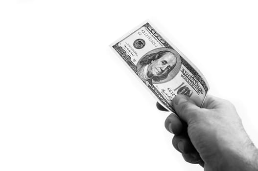 A hundred-dollar bill in his hand on a white background. Isolated. Black and white style. One hundred American dollars bill. One bill is dollars. The hand holds out the dollars. Place for logo, lettering, layout, layout.