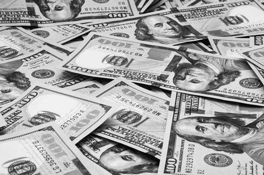 Cash hundred dollar bills, dollar background image. Scattered dollars. A big pile of dollars. Background of North American dollar bills. Black and white style. Top view for collage and presentation editing.