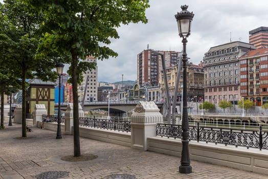 bilbao downtown with nervion river and boardwalk area, basque country, spain