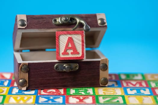 Capital letter A in treasure box in blue background