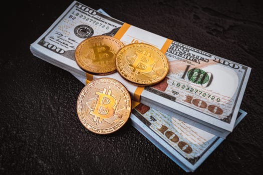 golden bitcoin metal coin on one US dollar bill