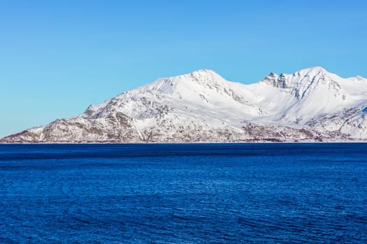Snow mountain with ocean in norway