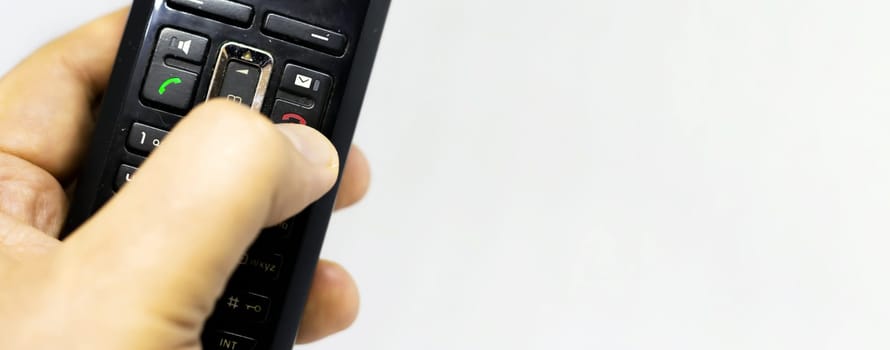 Thumb pushing the button with the red icon to reject or hang up a call on the phone. Landline telephony. Wireless phone. Copy space