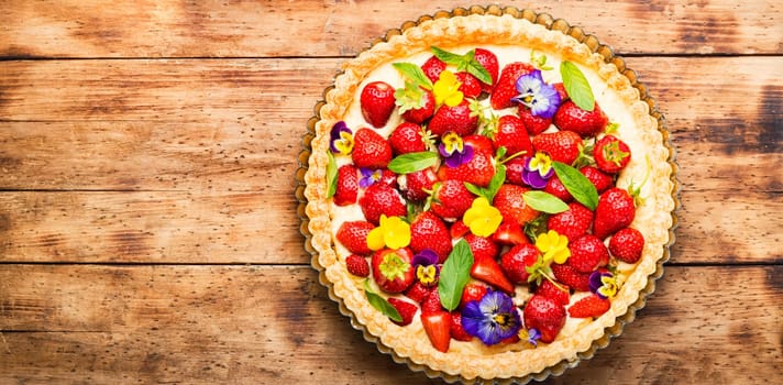 Summer tart with strawberries.Pie decorated with mint and flowers