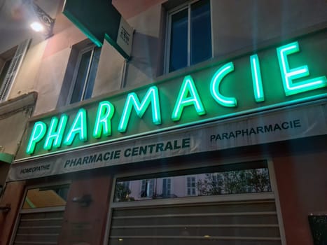Menton, France - July 2, 2021 : Pharmacy Neon Green Sign Lights, Facade Of A French Pharmacy At Night In Menton, France, Europe
