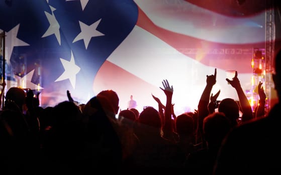 Crowd of people celebrating Independence Day. United States of America USA flag with fireworks background for 4th of July.