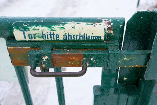 Gate on a garden path in Germany with the inscription Gate please lock