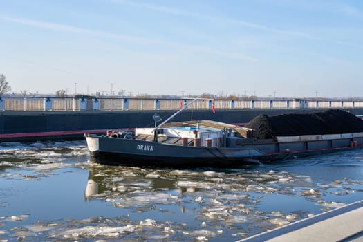 Barge Orava loaded with coal on the way over the trough bridge near Magdeburg in Germany in winter