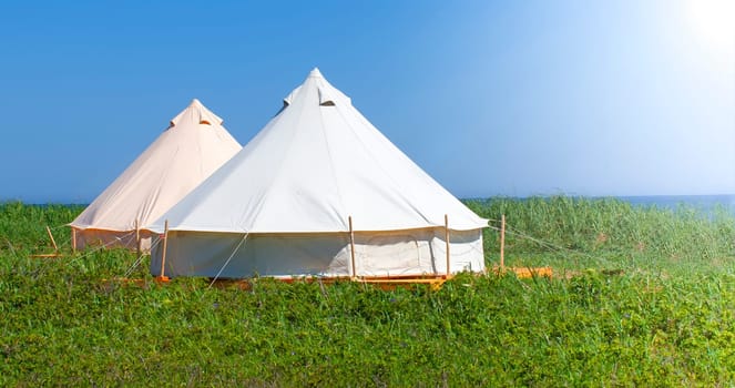 The Glamping house in the nature. Blue sky fnd green grass.