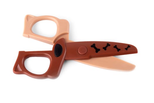The close up children's brown scissors isolated on white background