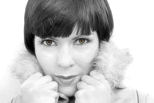 The face of young pretty woman with fur collar in black and white