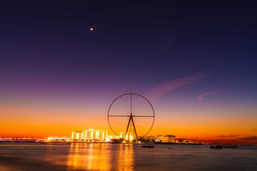 Twilight view of Bluewaters Island and Ain Dubai during construction, Dubai, UAE