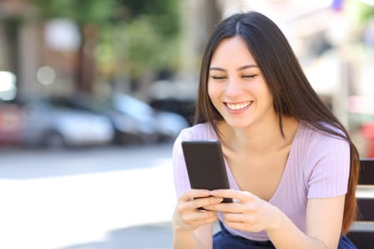 Asian woman using smart phone on a bench