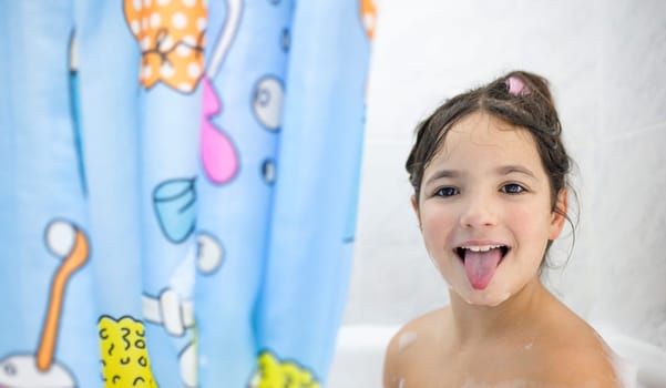 Child girl with enjoy bathing. Leisure time bathtub time for children concept