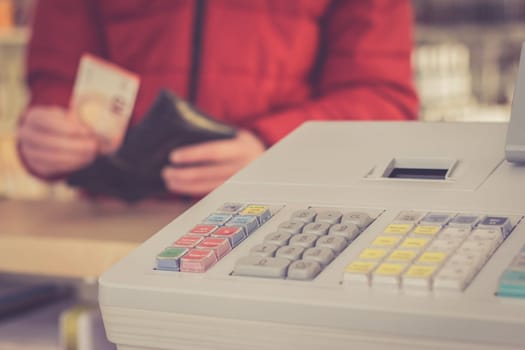 Cash register in a shop: Customer is paying purchase