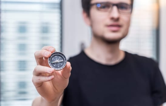 Young freelancer with compass holding in hand