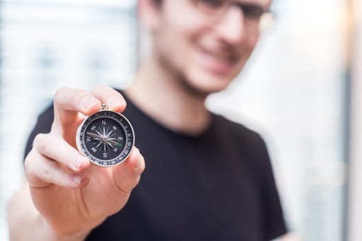 Young freelancer with compass holding in hand