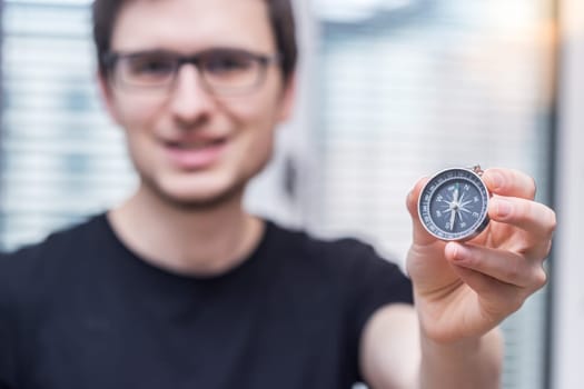Young freelancer with compass holding in hand
