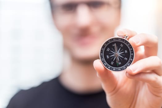 Young freelancer with compass holding in hand