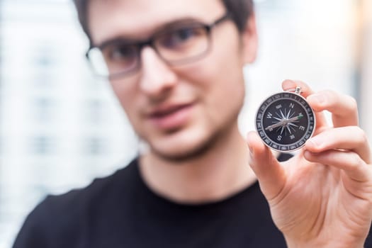 Young freelancer with compass holding in hand
