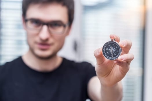 Young freelancer with compass holding in hand