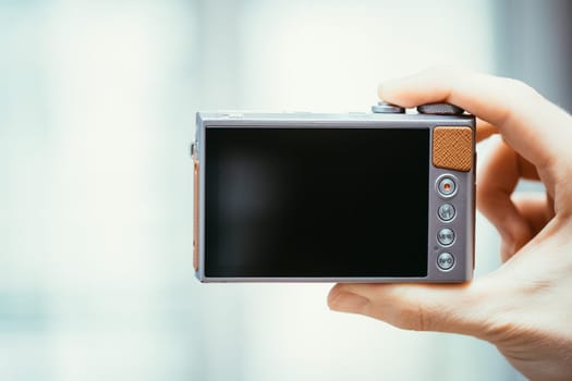 Reverse side of a digital camera, black lcd screen and some keys, business style