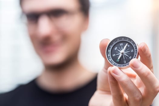 Young freelancer with compass holding in hand