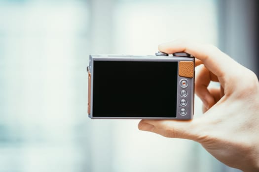 Reverse side of a digital camera, black lcd screen and some keys, business style