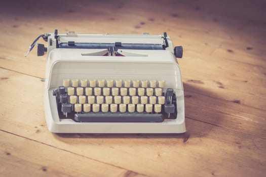 Vintage typewriter on a wooden desk, cutout