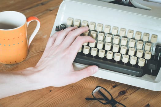 Vintage typewriter on a wooden desk, cutout