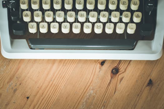 Vintage typewriter on a wooden desk, cutout