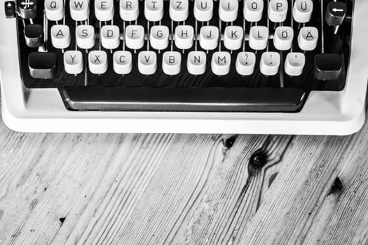 Vintage typewriter on a wooden desk, cutout