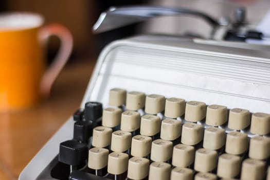 Vintage typewriter on a wooden desk, cutout