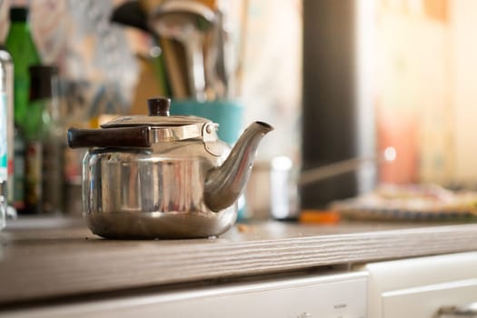 Metal tea cooker on a rustic old oven