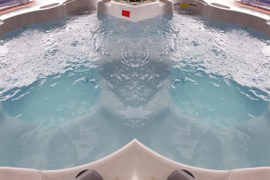 Large spa bath for spa treatments in the salon or inside a house. Empty Jacuzzi Tub Extra Large. Luxurious bathroom with whirlpool with underwater system