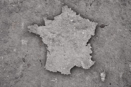Map of France on weathered concrete