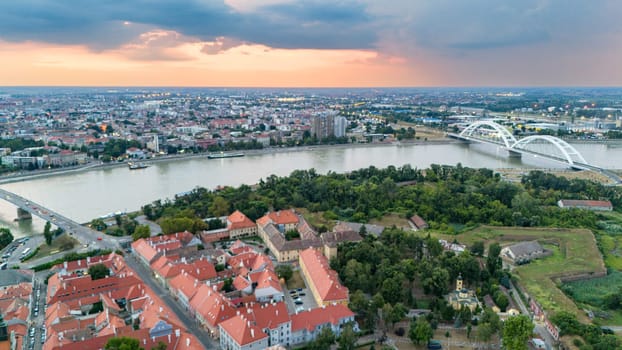 Scenic aerial view of Novi Sad Serbia featuring Petrovaradin fortress and Danube river at sunset