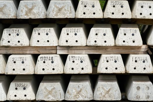 new numbered concrete railroad sleepers at the storage yard of a construction site in Magdeburg in Germany