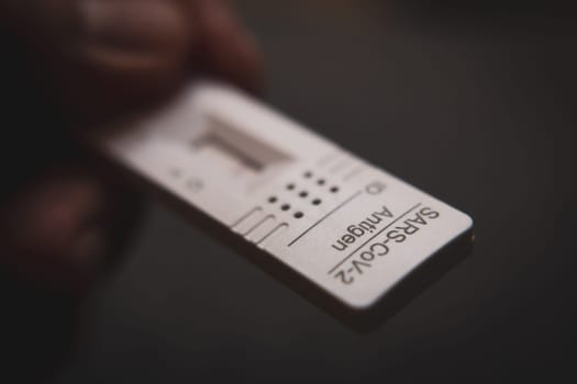 Patient Holding a Test Kit for Viral Disease SARS-CoV-2 or COVID-19 2019-nCoV with Negative Result.