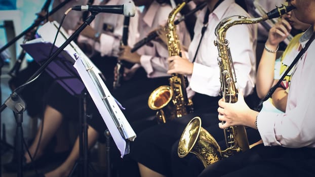 trumpeter plays her trumpet in the band during live concert