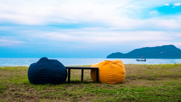 Empty Beautiful color black and yellow seat on the beach coat with blue sky mountain background. Abstract vacation happy holiday