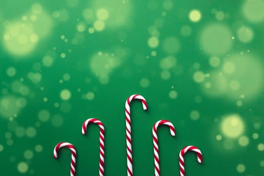 Christmas candies on green background, red white lollipop. High quality photo