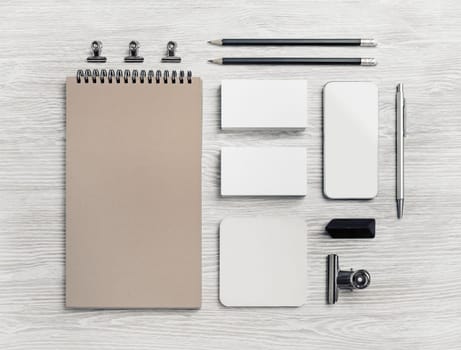 Blank stationery and corporate identity template on light wooden background. Responsive design mockup. Flat lay.